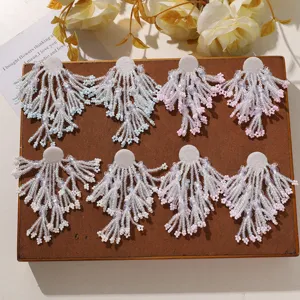 Close-up detail of handmade beaded tassel flower DIY patches, exquisite crystal bead design.