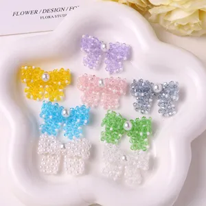 Detailed shot of handmade crystal beaded pearl bow DIY accessories in multiple colors.