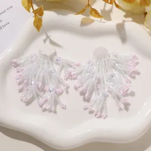 Handcrafted white pink beaded fringe flower patch DIY sewing earring accessories detail view.