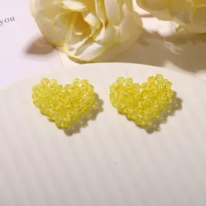 Yellow beaded heart detail close up, sparkling crystal craft accessory for handmade DIY jewelry.
