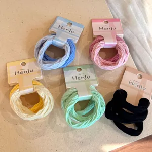 Detail view of candy color elastic hair tie sets with branded card packaging for daily wear.