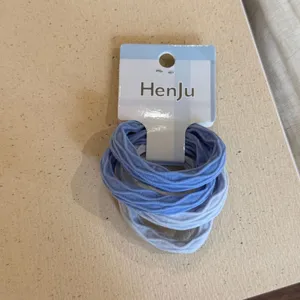 Detail shot of blue hair tie set with backing card, soft elastic material for daily styling.