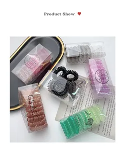 Transparent boxed spiral hair ties, closeup detail showing colorful elastic coil bands.