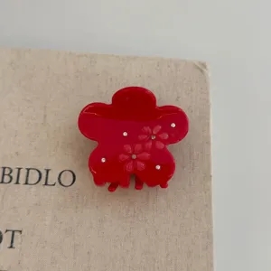Red flower hair claw clip detail, resin shark clip with rhinestones, cute hair accessory.