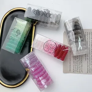 Colorful plastic telephone hair ties in clear boxes, chic minimalist hair accessories for women.