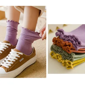 Detail shot of Japanese style ruffle cotton mid-calf socks in multiple colors and wear.