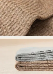Close-up view of ribbed knit socks fabric texture showing fine weave and breathable soft cotton quality.