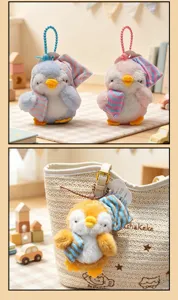 Cute plush penguin keychain backpack pendant wearing sleeping cap soft toy detail view