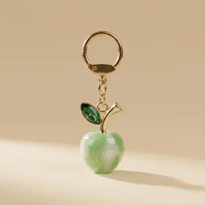 Green acrylic apple bag charm and stylish metal keychain for women daily use variant.