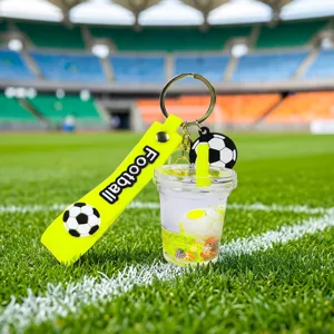 Detailed view of the acrylic oil quicksand football keychain pendant in stadium scene.
