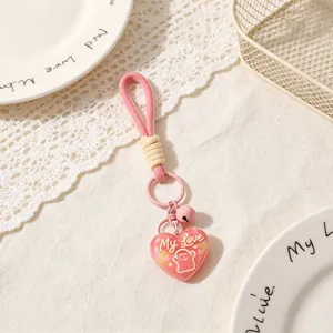 Cute pink heart keychain bag charm with bell and sweet love graphic for women and girls.
