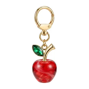 Crystal apple keychain and bag charm with gold hardware and green leaf pendant for gifts.