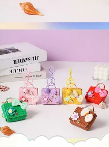Detailed view of colorful DIY leather mini bag keychains with cute flower and bow decorations.