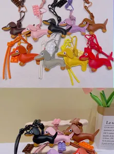 Cute leather dachshund bag charm and keychain with chocolate pendant, creative accessories.