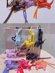 Detailed view of colorful leather dachshund dog bag charms and cute chocolate pendants for accessories.