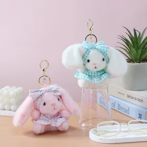 Plush rabbit keychain detail, cute stuffed animal bag charm with plaid dress and metal clasp.