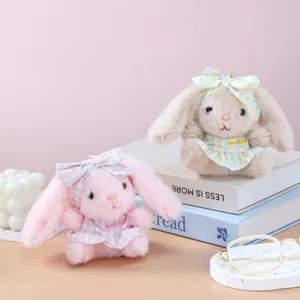 Cute plush bunny keychain detail shot featuring soft fabric and sweet plaid dress bow design.