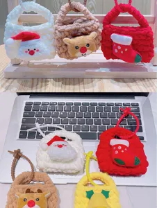 Detailed view of cute cartoon knitted mini Christmas coin purses, handmade woven keychain bags.