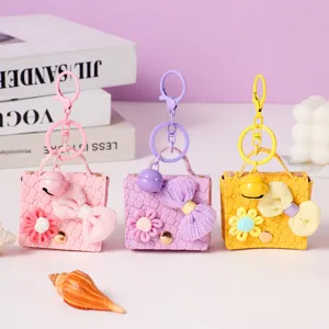 Cute woven leather mini bag keychain purse charm with flower bow and bell for women keys.