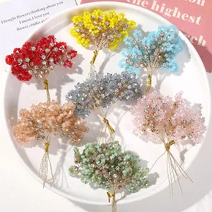 Close-up of colorful crystal beaded flower DIY materials arranged neatly on white plate.