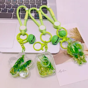 Grüner flüssiger Treibsand Schlüsselanhänger Acryl Tasche Anhänger mit Weizen und Glocke.