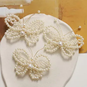 Handmade pearl butterfly hair clip DIY accessory detailed shot, elegant design for styling.