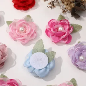 Detailed shot of colorful mesh flower DIY handmade hair accessories with faux pearl accents.