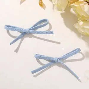 Light blue fabric ribbon bow accessory for DIY crafts, hair clips and shoes. Detailed view.