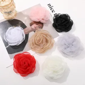Vue détaillée d'accessoires de fleurs en tissu mesh faits main, patchs floraux DIY pour vêtements.