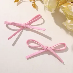Pink fabric bowknot DIY accessory detail shot, sweet style ribbon bow for shoes and hair clips.