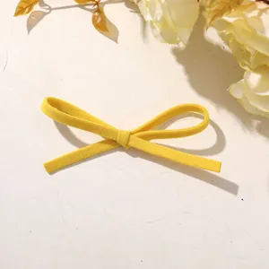 Yellow fabric bow detail shot, perfect for DIY hair clips, shoes, and bag accessories.