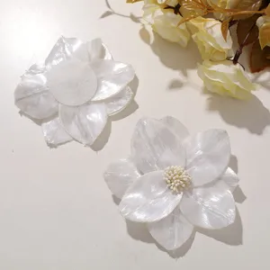 Detailed view of white shiny fabric flower DIY accessories, perfect for brooches and headwear.