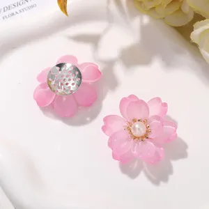 Close-up of pink flower DIY craft charms, resin floral jewelry accessories for handmade earrings.