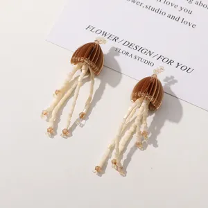 Detailed shot of handmade beaded jellyfish tassel earrings with unique design, perfect for stylish outfits.
