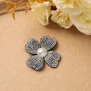 Exquisite rhinestone four-petal flower DIY accessory with central pearl for craft and hair.