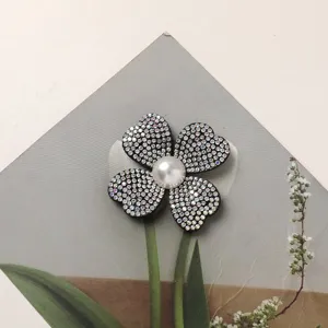 Rhinestone four-petal flower DIY patch with central pearl, perfect for shoes and hair accessories.