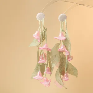Green leaf sheer fabric lily of the valley flower earrings detail DIY handmade jewelry accessory.