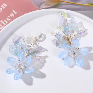 Close-up detail of handmade blue crystal flower hair clips with beading, delicate and elegant design.