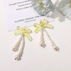 Stunning long pearl pendant iridescent bow earrings, elegant handmade beaded drop earrings for women.