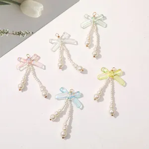 Detail view of iridescent bow pearl pendant DIY jewelry accessories for handmade crafts and earrings.