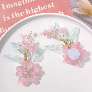 Detailed close-up of handmade crystal flower hair accessory DIY material, pink petals.