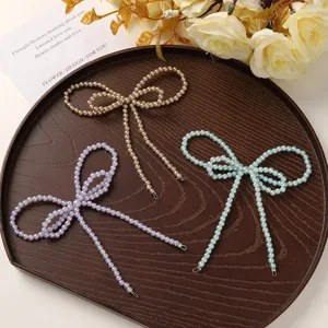 Exquisite detail view of imitation pearl bow DIY handmade accessories in assorted colors.