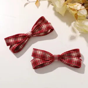 Detailed view of red plaid fabric hair bow clip, Korean preppy vintage style hair accessory.