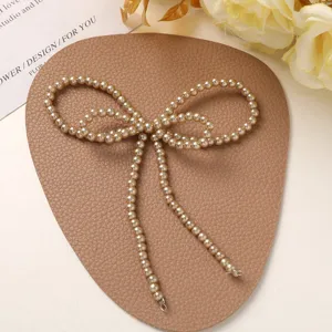 Pearl bow DIY handmade accessory, delicate detail shot for shoes, bags and jewelry crafting.