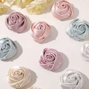 DIY satin rose flower charms with pearl embellishments for hair accessories and clothing.