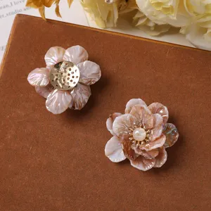 Detailed view of handmade gradient acrylic flower charms with pearl center for DIY crafts.