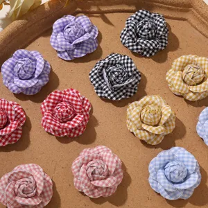 Detailed shot of cute plaid camellia flower fabric accessories for diy crafts and hair.