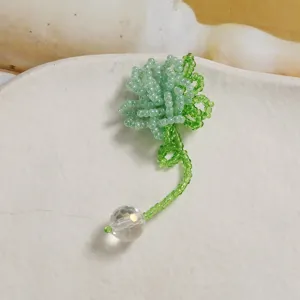 Handmade green beaded flower pendant DIY crystal ball jewelry accessory detail view.