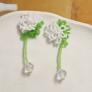 Handcrafted beaded flower earrings with crystal ball pendants, detailed close-up view.