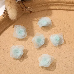 Miniature mesh rose flower heads for DIY hair accessories and clothing decoration crafts.